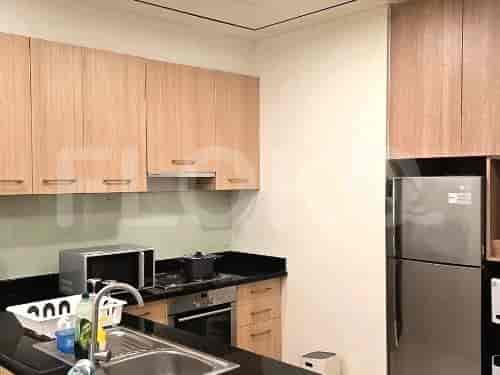 A modern kitchen with wooden cabinets and black countertops.