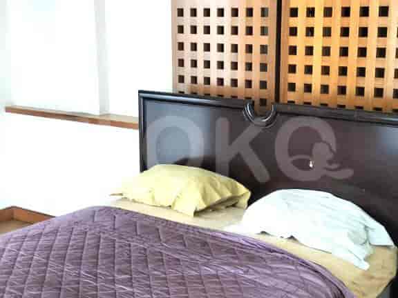 A bedroom with a bed, headboard, and pillows.