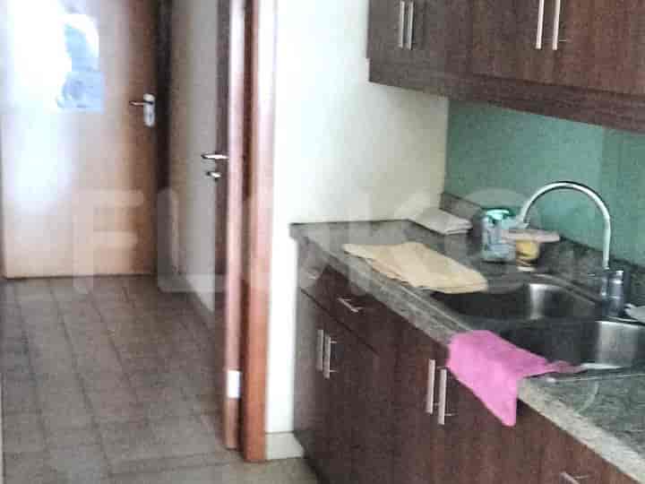 A kitchen with a sink, countertop, and doorway.