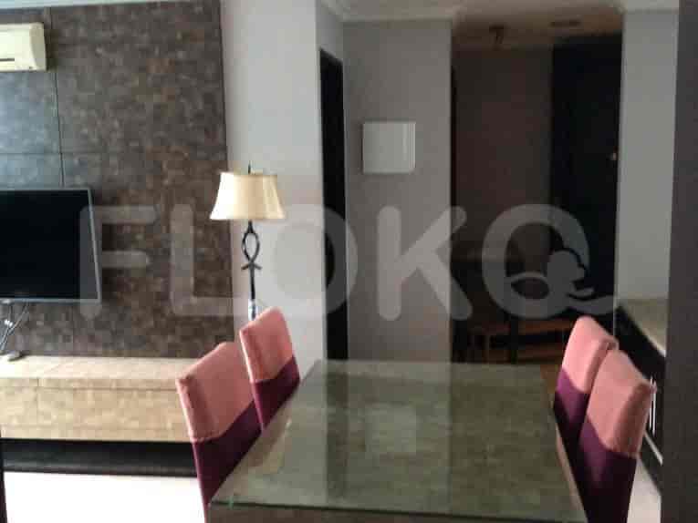 Dining table with chairs and wall decor.