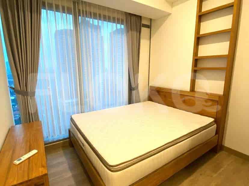 Kamar tidur dengan rangka tempat tidur kayu dan pemandangan kota.