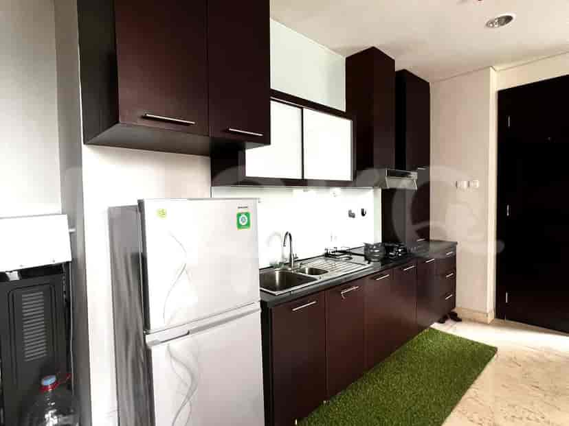 Modern kitchen featuring dark wood cabinetry and stainless steel appliances.