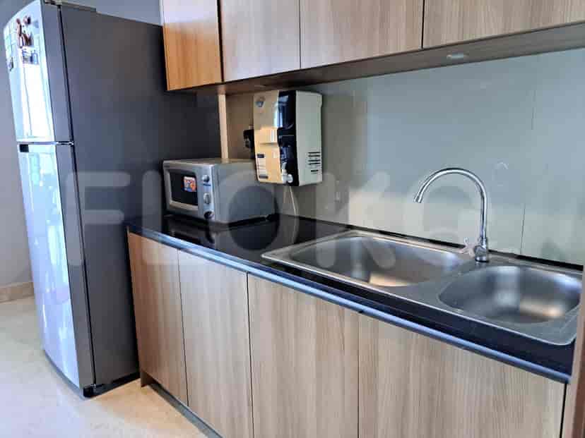 Modern kitchen with wooden cabinetry and stainless steel appliances.