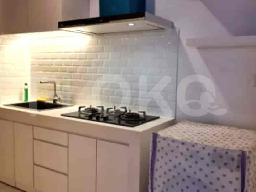Modern kitchen with white cabinets, gas stove, and a white backsplash.
