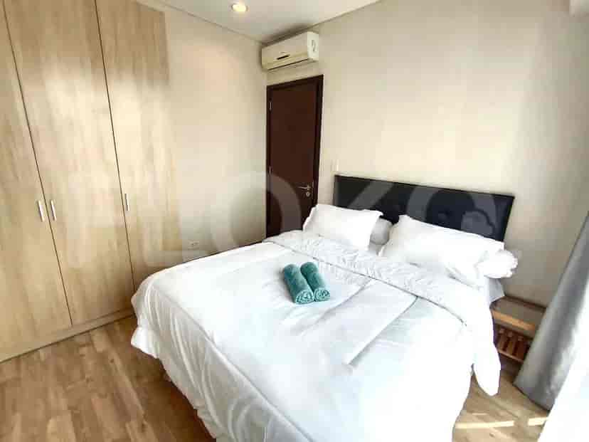 Bedroom with a bed, closet, and air conditioning unit.