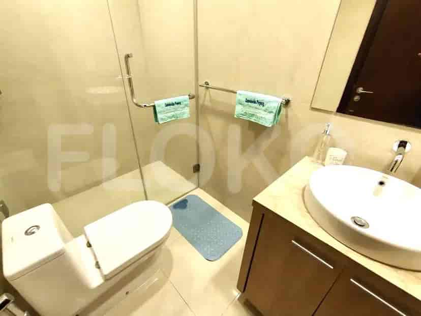 Bathroom with a toilet, sink, and shower.