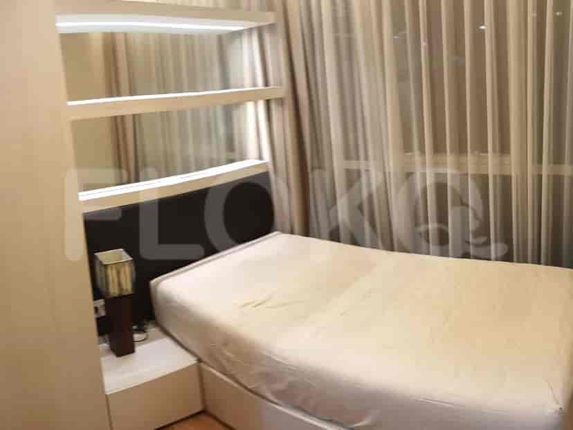 Bedroom featuring a bed, bedside table and closet.
