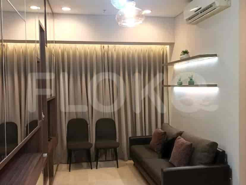 Cozy living room with a sofa, two chairs, and curtained window.