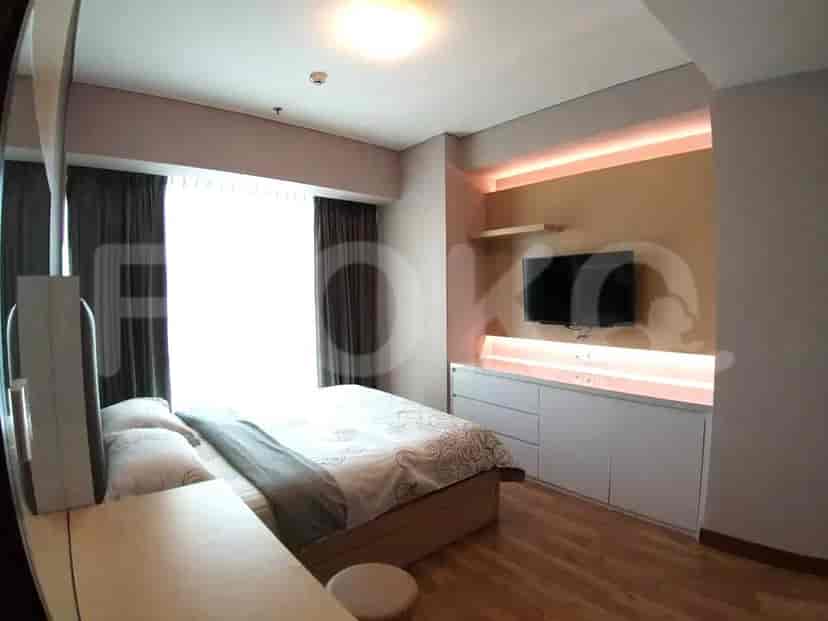 Bedroom with a large bed, television, and minimalist design.