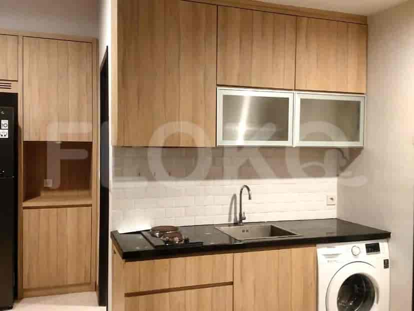 Modern kitchen with wooden cabinets and appliances.