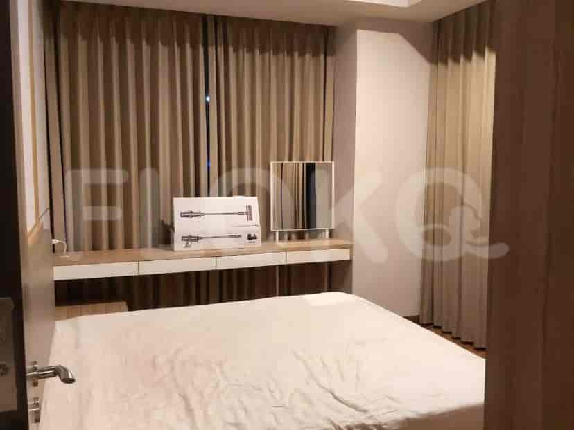 Bedroom with a bed, desk, and curtains.