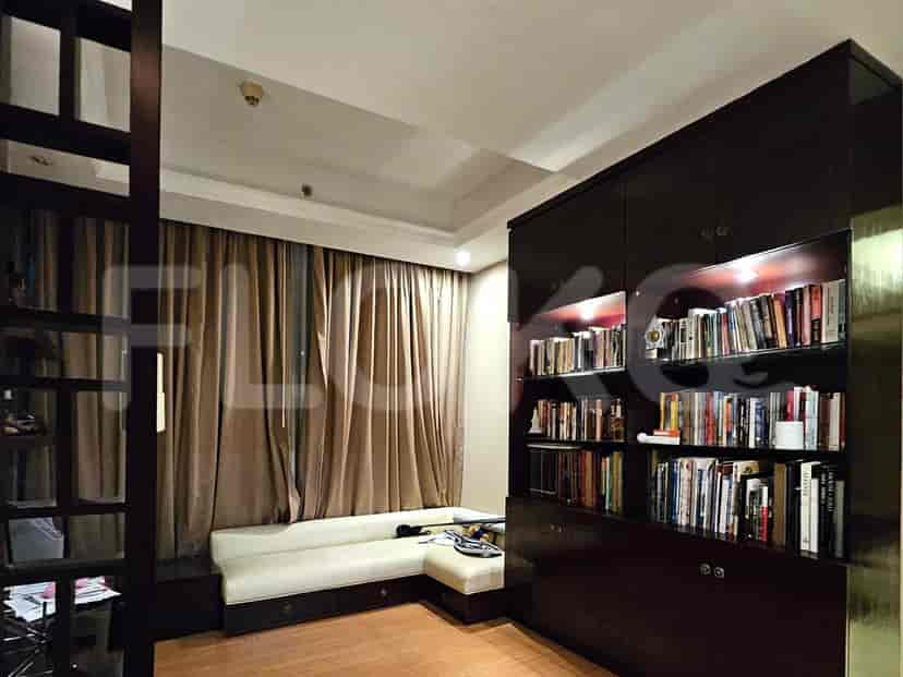 A study area with built-in shelves and a window seat.