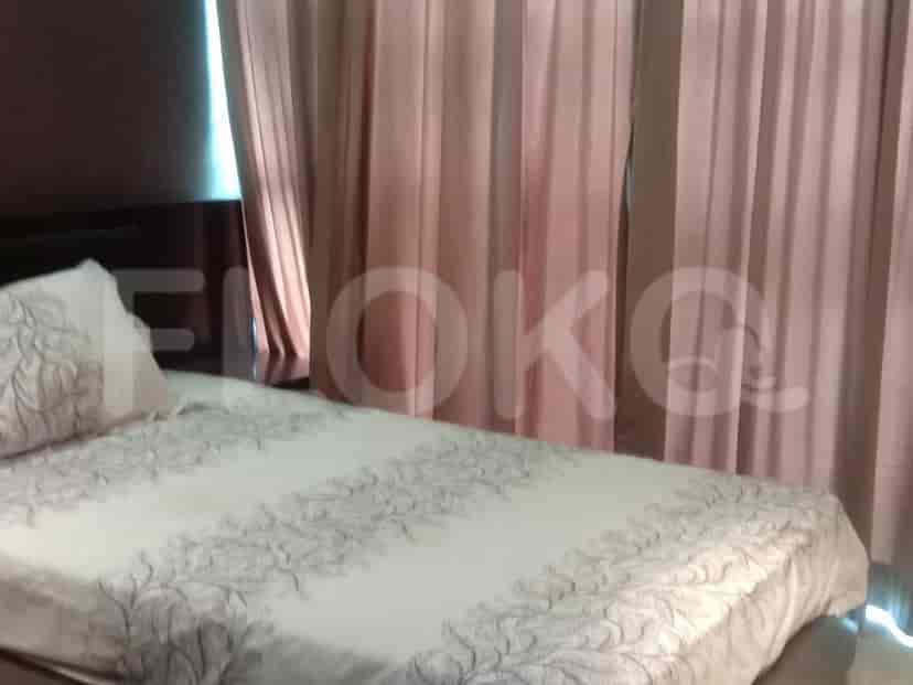 Bedroom featuring a bed with a floral patterned comforter.