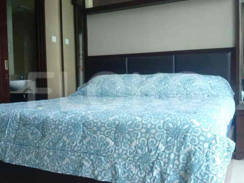 Bedroom featuring a bed with a patterned comforter.