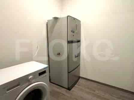 A laundry area with a washing machine and a refrigerator.
