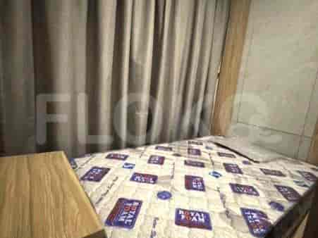 A bedroom with a bed and curtains.