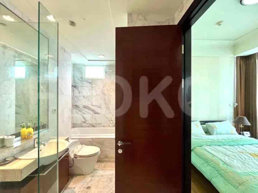 Bathroom with a shower, sink, and a glimpse into the bedroom.