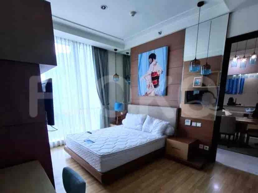 Bedroom featuring a double bed, artwork, and a large window.