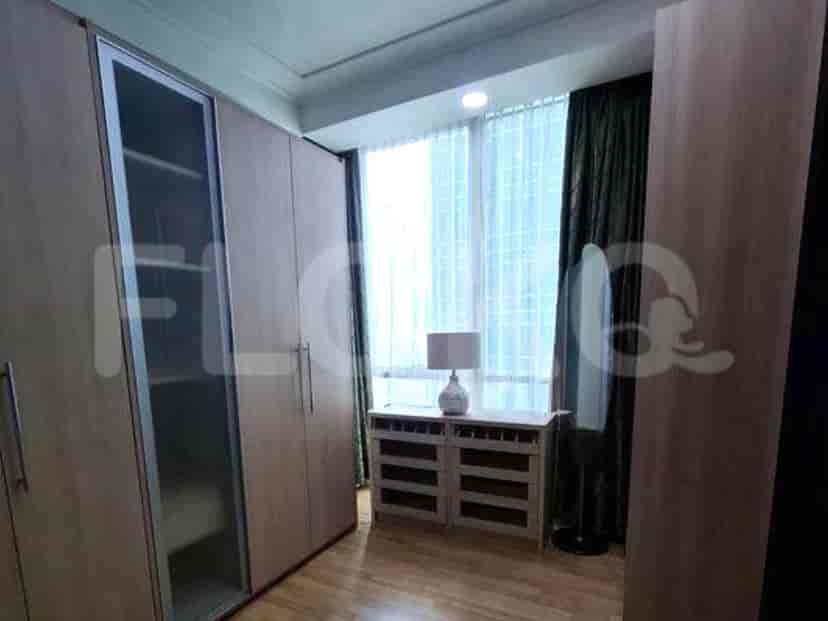 Bedroom closet with built-in wooden wardrobes and a dressing table.