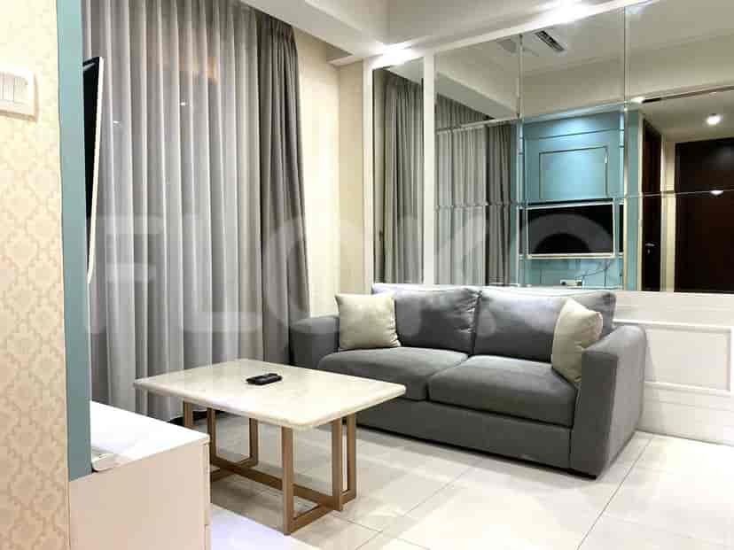 Modern living room featuring a grey sofa, marble coffee table, and large window.