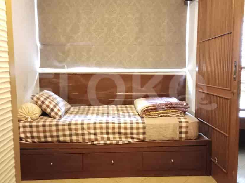 Bedroom with a daybed and window coverings.