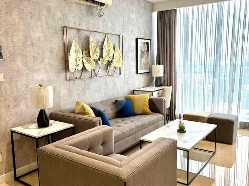 A modern living room featuring a grey sofa, marble coffee table, and decorative wall art.