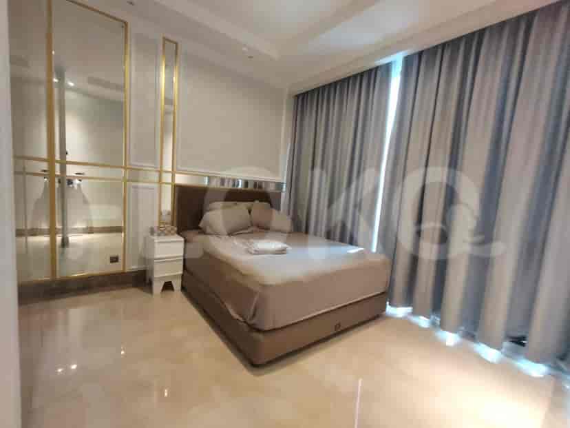 A bedroom with a bed, mirrors, and curtains.