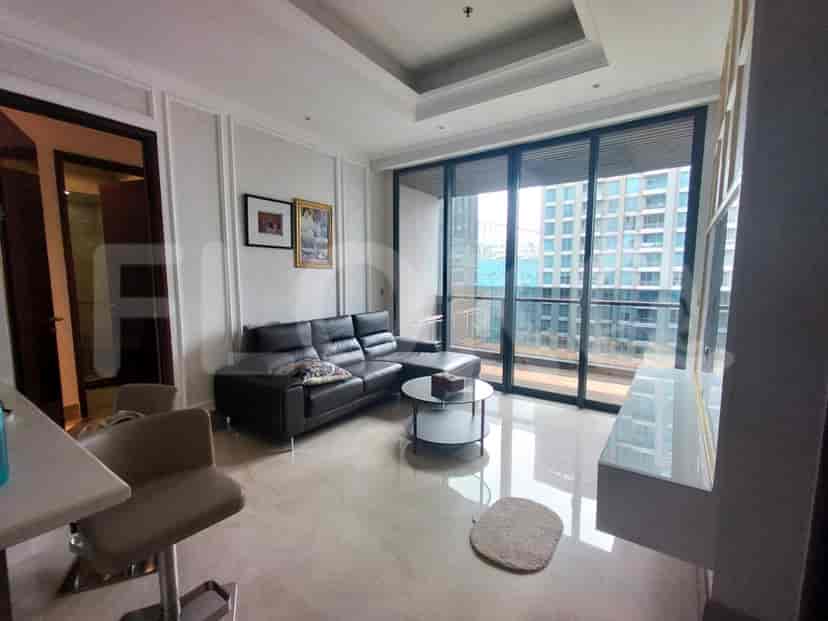 A modern living room with a leather sofa, coffee table, and city view.