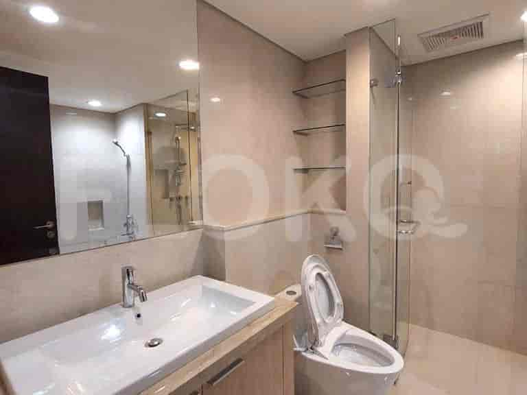 A modern bathroom featuring a glass-enclosed shower and a large mirror.