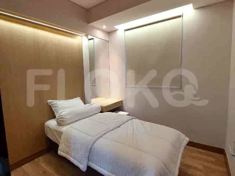 A guest bedroom featuring a single bed and a minimalist design.