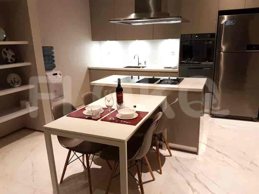 Kitchen and dining area with a table set for dinner.