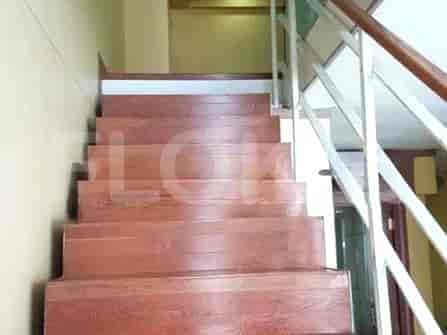 A staircase with wooden steps and a white railing.