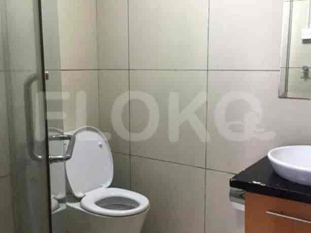 A bathroom with a toilet, sink, and a shower.