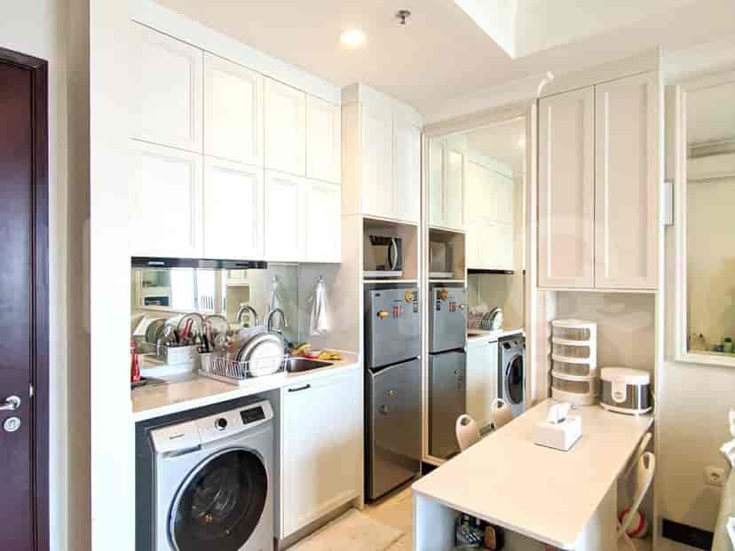 Compact and functional kitchen with appliances and storage.