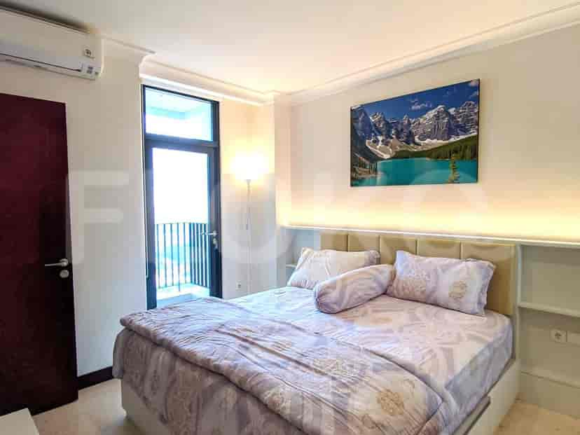 Bedroom with a bed, art, and a balcony.