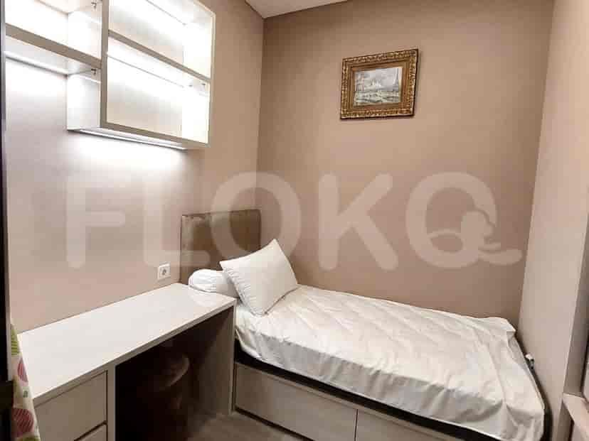 Small bedroom with single bed and a desk.