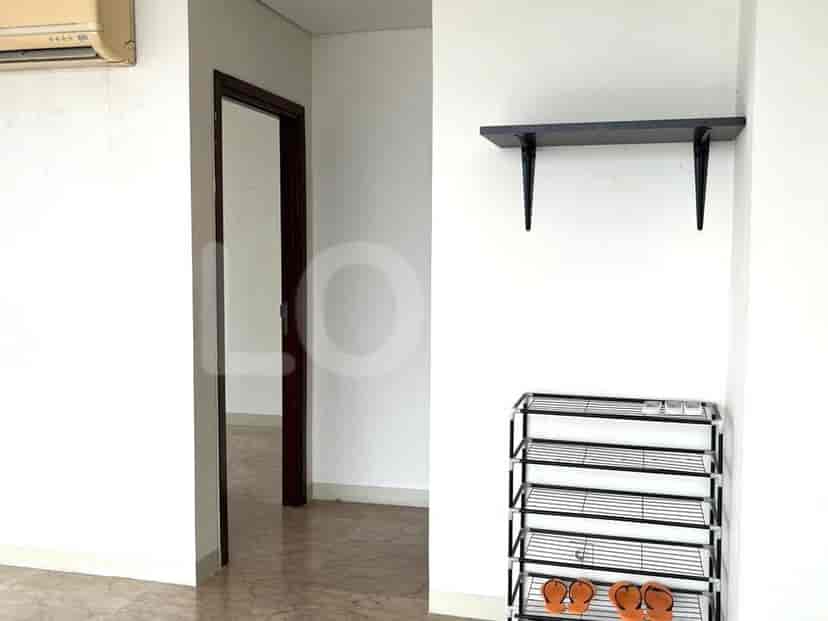 A hallway with a doorway leading into another room.