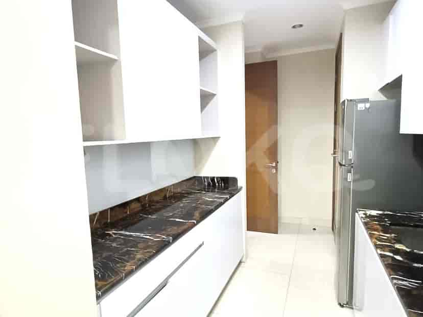 A modern kitchen with white cabinets, dark counter tops.