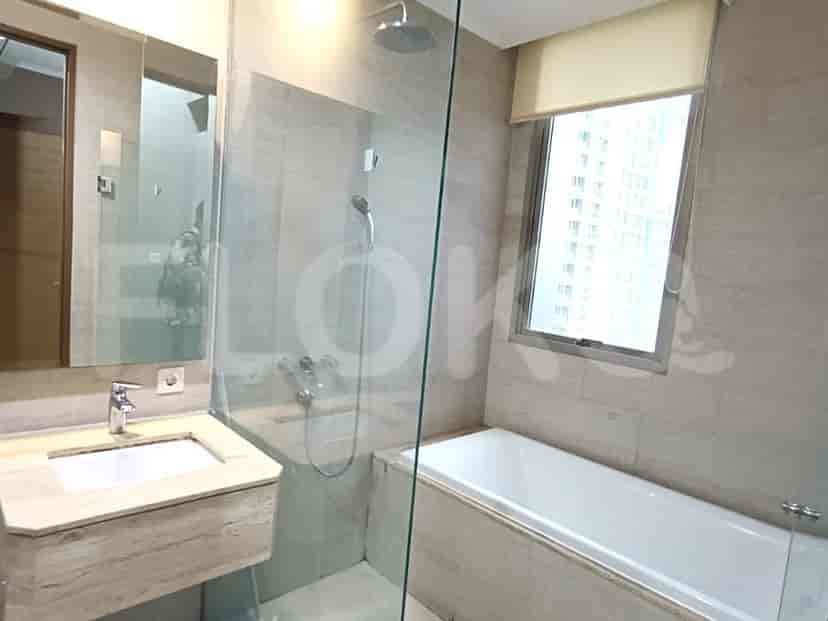 A bathroom with a bathtub and glass shower door.
