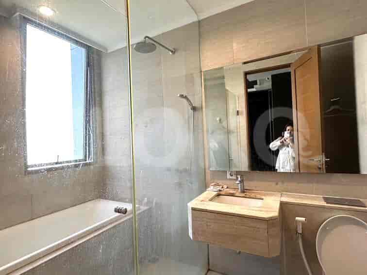 A modern bathroom with a bathtub, shower and vanity.
