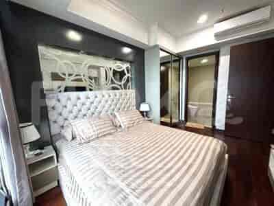 Spacious master bedroom with a large bed, mirror, and access to the bathroom.