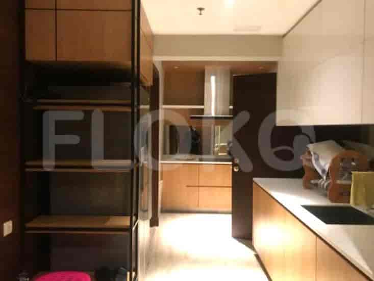 A modern kitchen with wooden cabinets and white countertops.