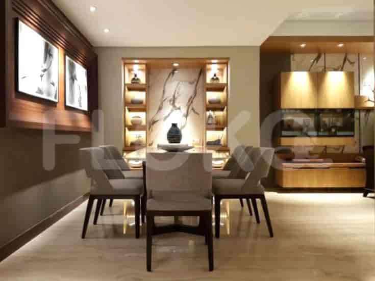 A modern dining room with a table and chairs.