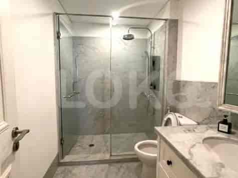 Bathroom with a glass shower and white fixtures.