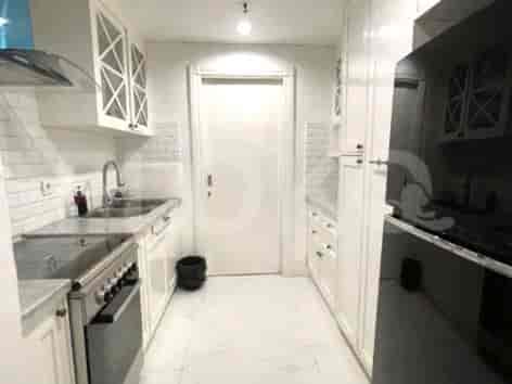 Kitchen with white cabinets, stove, and sink.