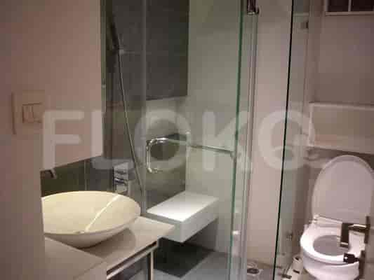 A modern bathroom with a shower, toilet and sink.