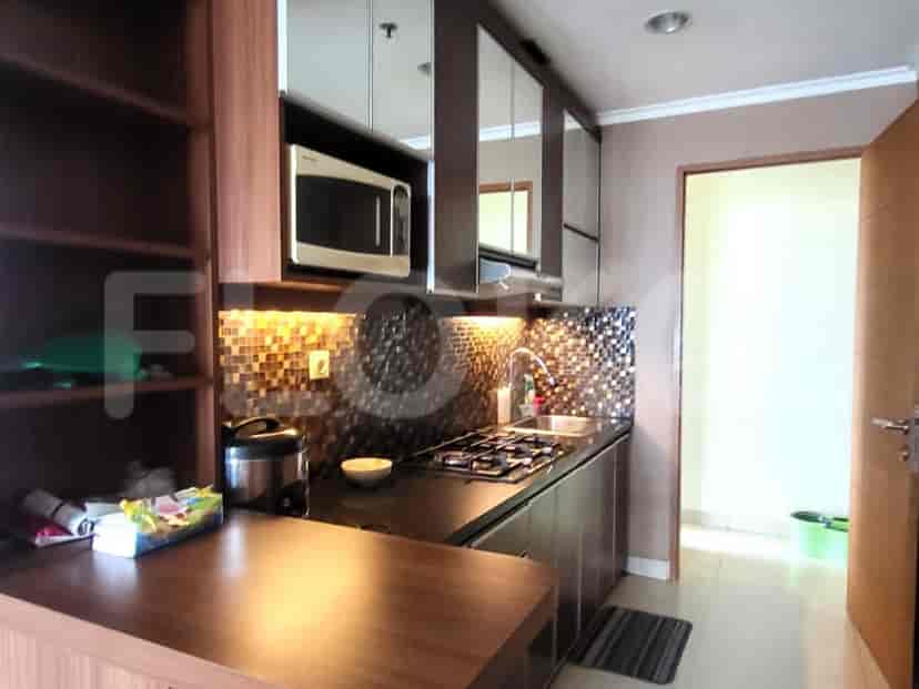 A kitchen with cabinets, a stove, and a microwave.