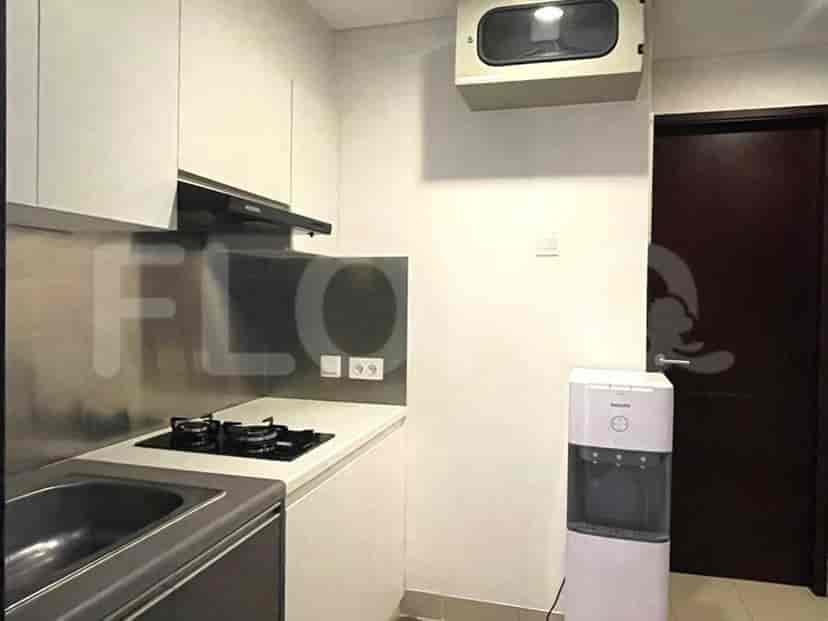 A modern kitchen with white cabinets and a gas stove.