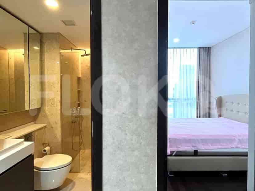 Bathroom with a walk-in shower and bedroom visible through doorway.