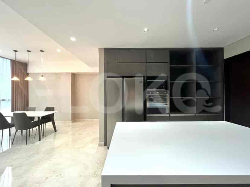 Modern kitchen with stainless steel appliances and a dining area.